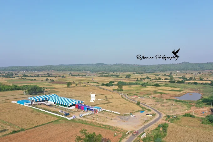 Aerial view of Shubham Gardens and the surrounding village landscape